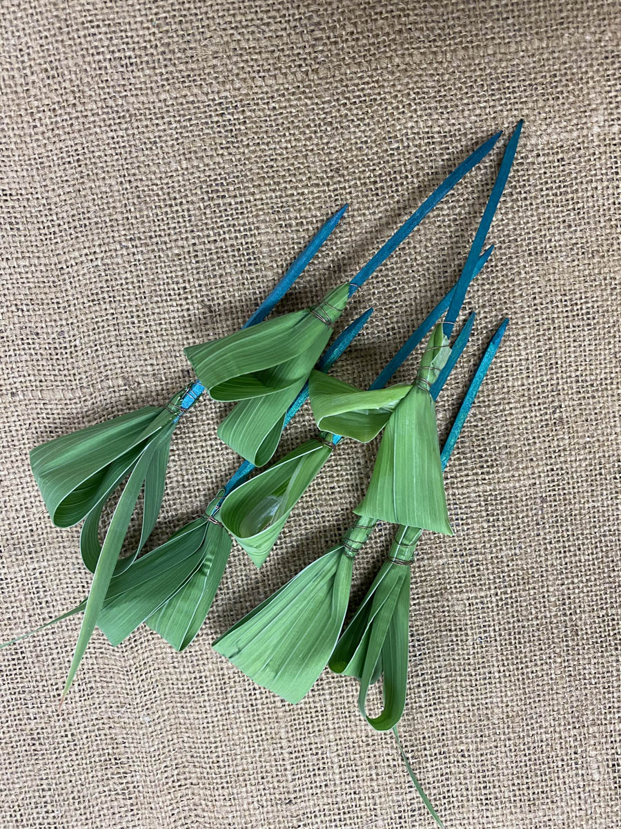 Figure 11 Foliage AccentsSeven gladiolus leaves are shown decoratively looped around wired wood picks.
